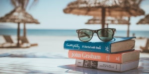 Holiday pay and commission - books and sunglasses on a beach